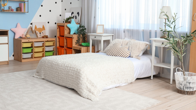 Floor bed with white blanket in toddler's room