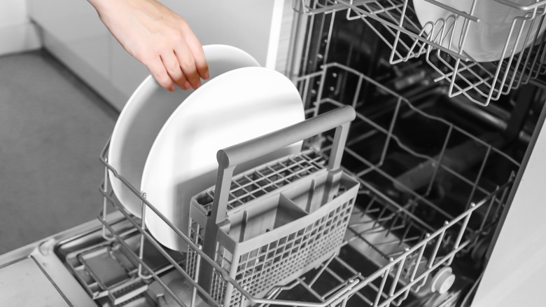 hand unloading dishwasher