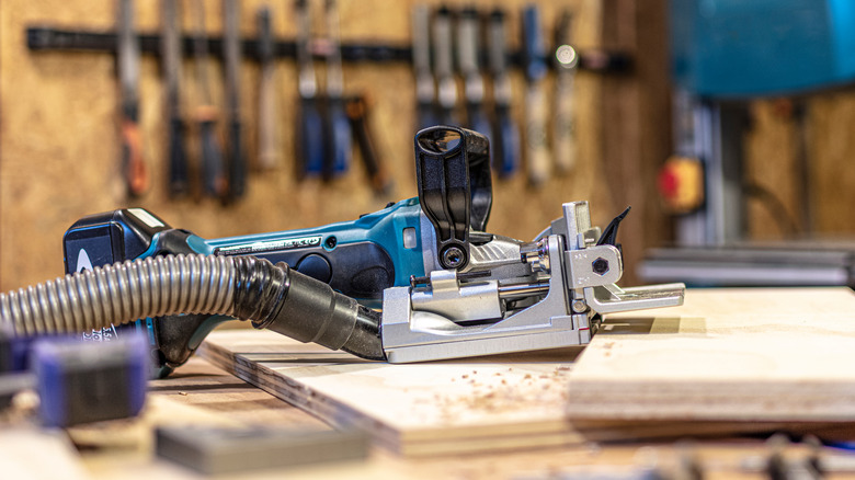 person using biscuit joiner tool