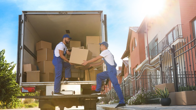 Movers putting boxes into truck