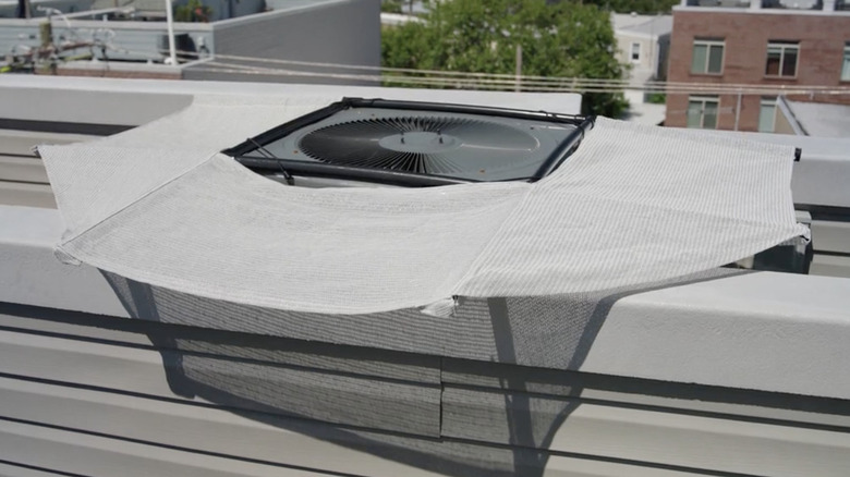 AC Shade set up on AC unit on edge of building roof