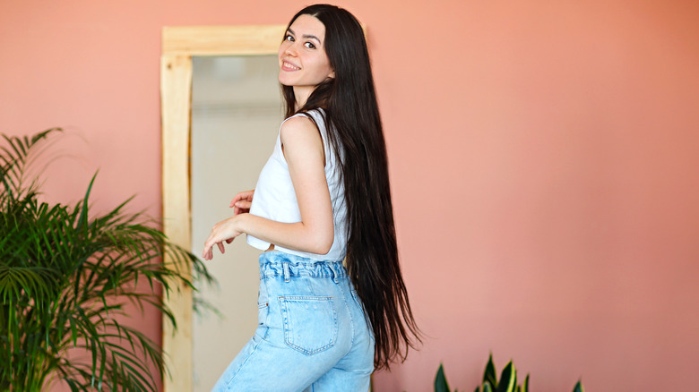 woman standing by pink walls