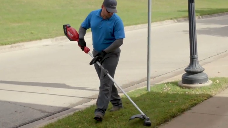landscaper trimming grass