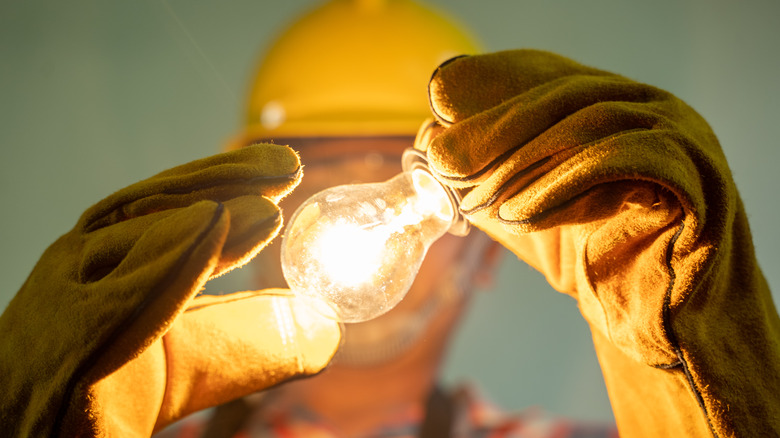 contractor holding a lightbulb