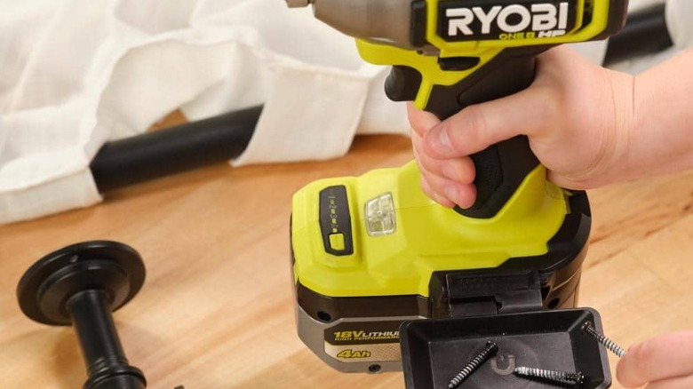 Someone using the magnetic tray of Ryobi's Rail System Accessory Set