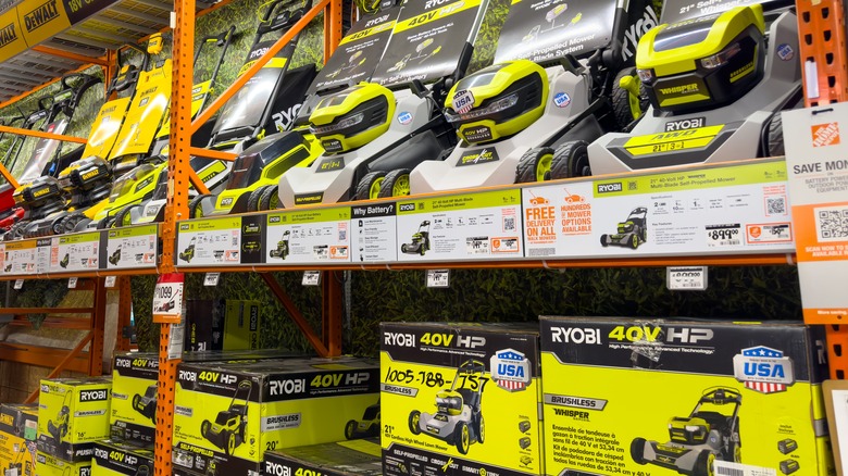 A view of several Ryobi lawn mowers, on display at a local retail store.