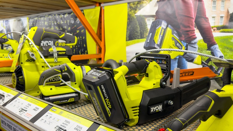 Ryobi lawn equipment displayed on a retailer's shelf.