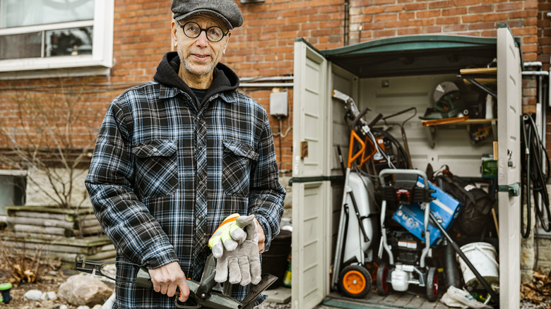 Man with tools in shed