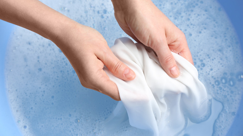 Person holding wet fabric