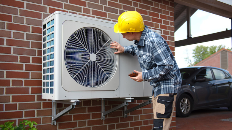 An engineer fitting a heat pump