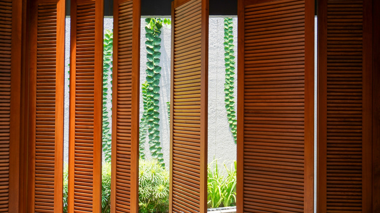 Partially-opened vertical blinds made of teak wood
