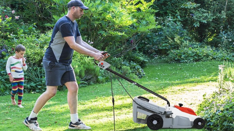 A man using the PayLessHere electric corded lawn mower