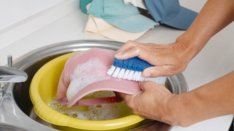 hand scrubbing a hat