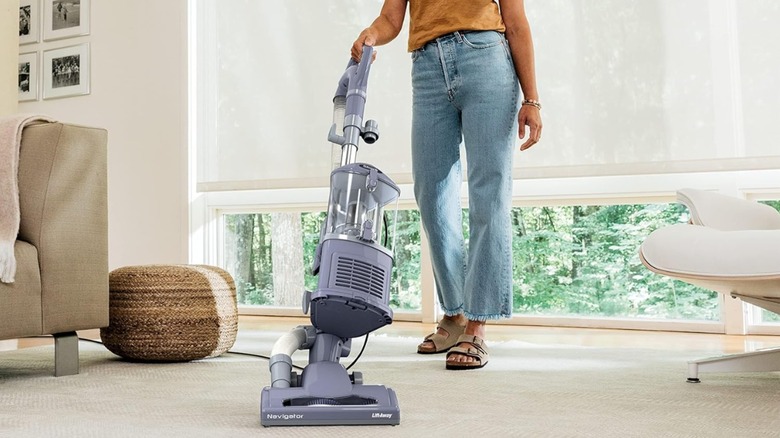 person vacuuming large room