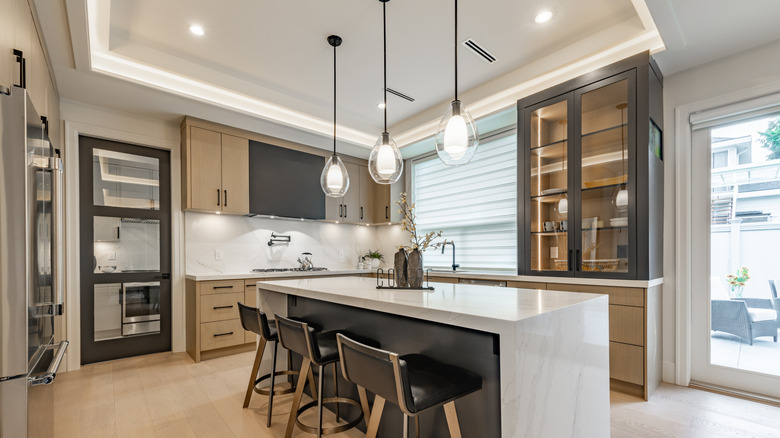 Kitchen with recessed lights, pendant lights, and under-cabinet lights.