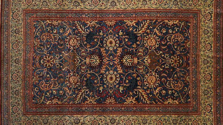 An asymmetrical red Persian rug