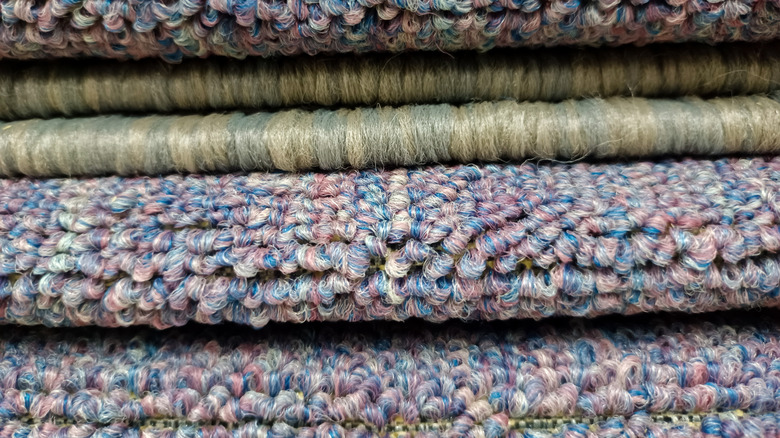 A stack of folded rugs showing their individual piles