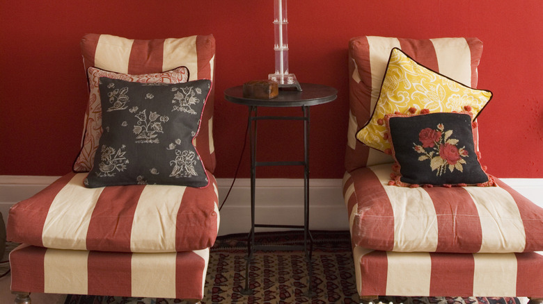 Home interior with red and white circus stripe chairs, and a red-painted wall