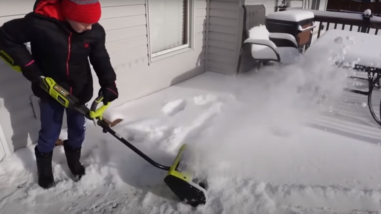 man using Ryobi snow shovel