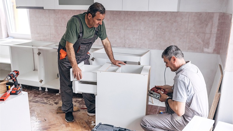 Two people remodeling kitchen