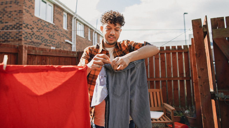 Man hanging clothes on line