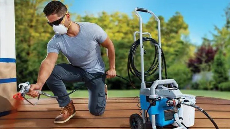 A person using the Avanti airless paint, primer and stain sprayer