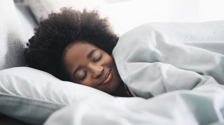 Woman sleeping in comfy bed