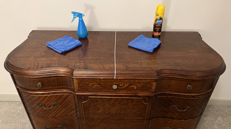 dusting sprays on wooden dresser