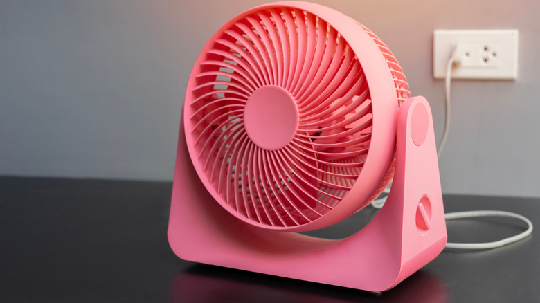 pink desktop fan sitting on a desk