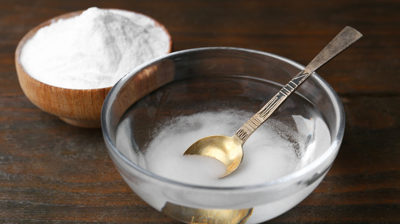 Baking soda being mixed with water in a bowl.