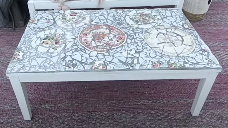 A DIYer used broken plates as tile to give her outdoor coffee table a makeover.