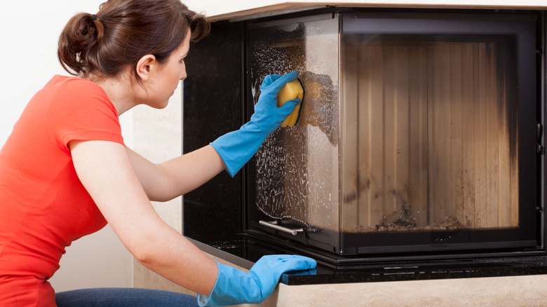 hand cleaning marble fireplace surround