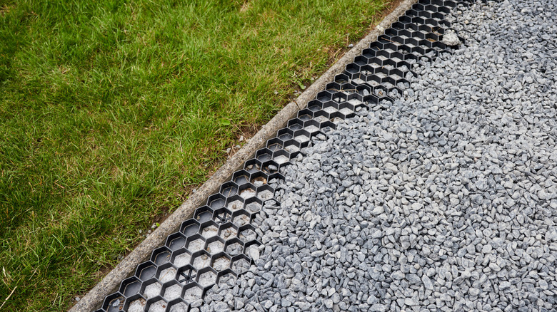 Gray marble gravel being installed for driveway
