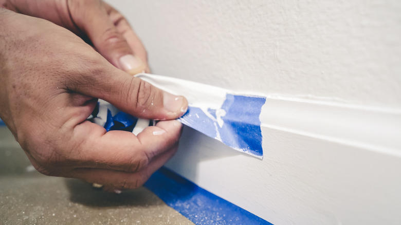 person using painter's tape