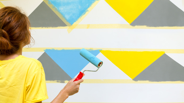 woman painting a wall