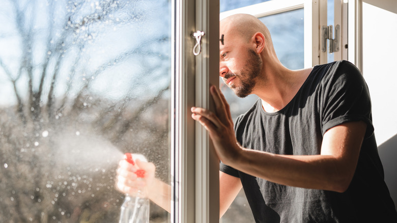 Man cleaning window