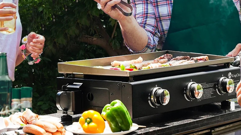 Product image of KingChii griddle being used outside