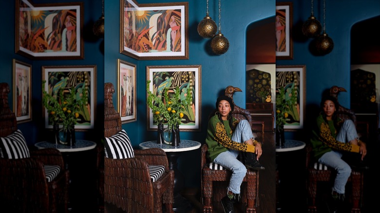 Woman sitting in a hand carved eagle chair
