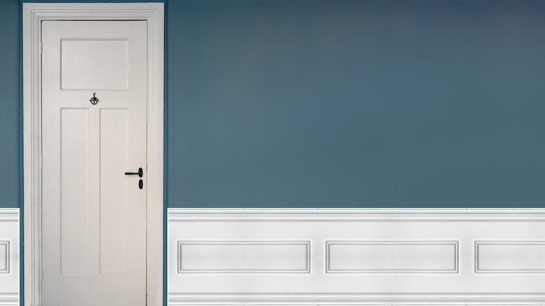 Teal wall with white door