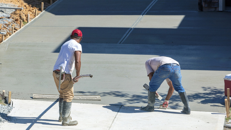 Workers making a new concrete driveway