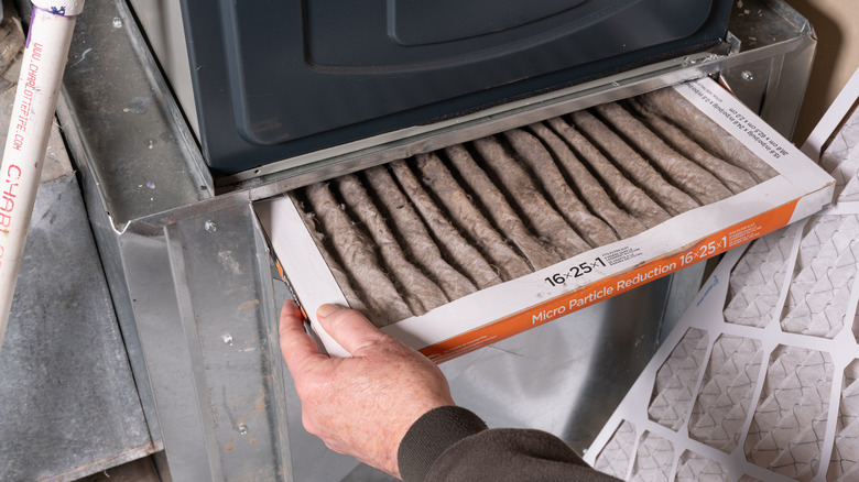 changing out a dirty furnace filter