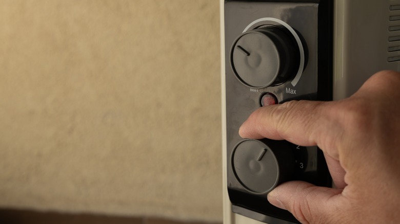 Someone turning off an electric heater