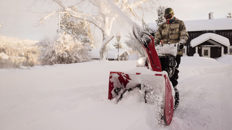 person using snow blower