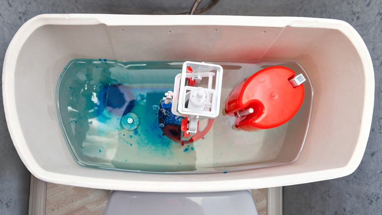 Top down shot of a blue toilet tab dissolving in a toilet tank