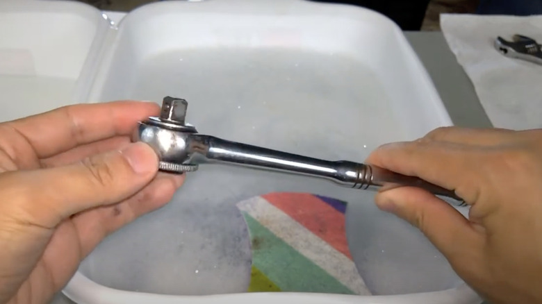 Cleaning grease off tool with soapy water
