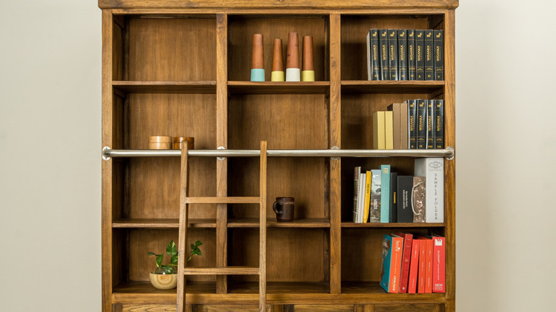 A teak bookshelf with decor.