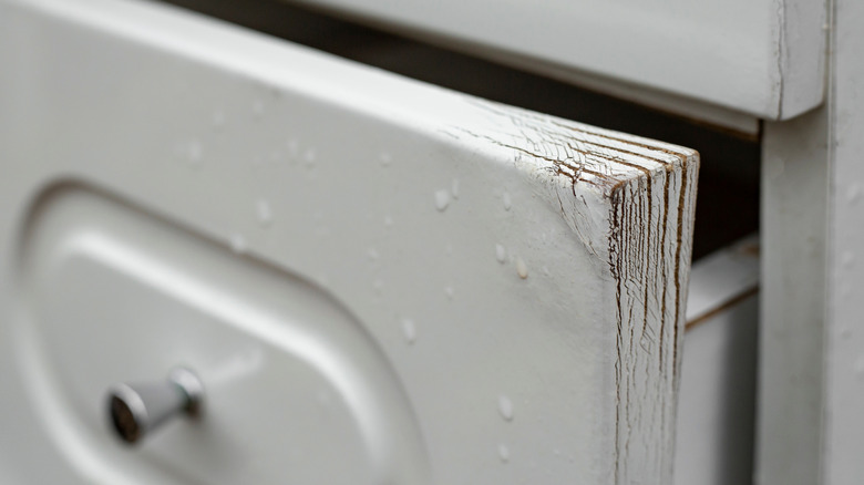 Water-damaged melamine-coated MDF that is swollen and delaminating