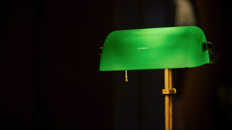 Banker's lamp turned on in dark room