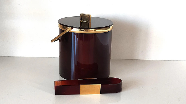 A brown and gold vintage ice bucket on a whtie background