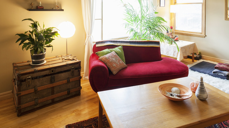 chest in a living room with red settee